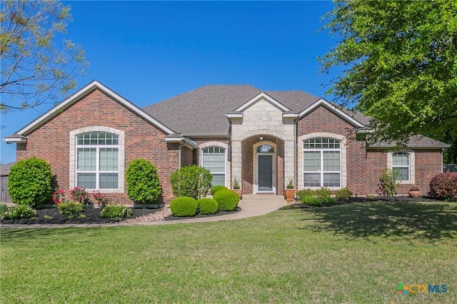 single story home featuring a front lawn and brick siding