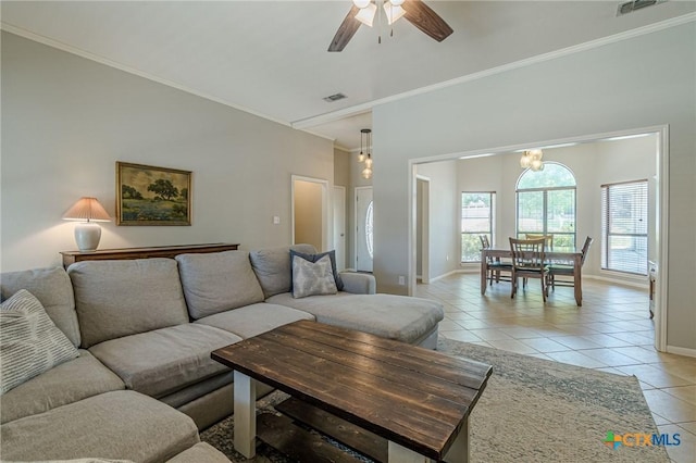 806 Northstar Loop, New Braunfels, TX 78130 - living area with light tile patterned floors, ornamental molding, baseboards, a ceiling fan, and a chandelier