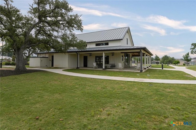 1531 Esser Xing, Canyon Lake, TX 78132 - view of front of home featuring a front lawn, covered porch, concrete driveway, and a metal roof