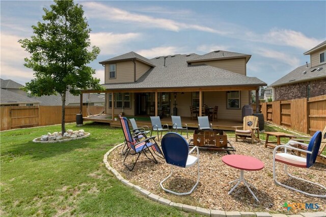 1531 Esser Xing, Canyon Lake, TX 78132 - back of house with a fenced backyard, a shingled roof, and an outdoor fire pit