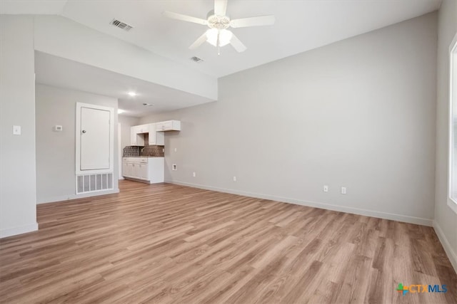 unfurnished living room with light wood-type flooring and ceiling fan