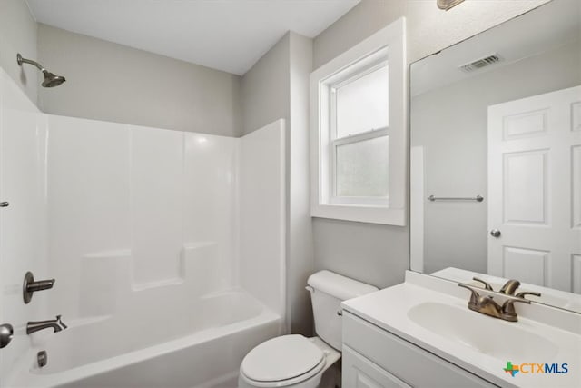 full bathroom with toilet, vanity, and  shower combination