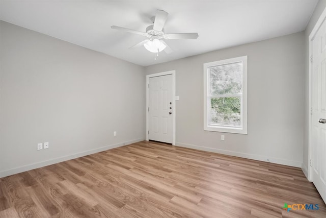 empty room with light hardwood / wood-style floors and ceiling fan