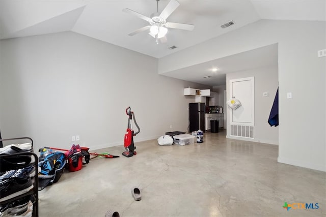 interior space featuring ceiling fan, concrete floors, and lofted ceiling