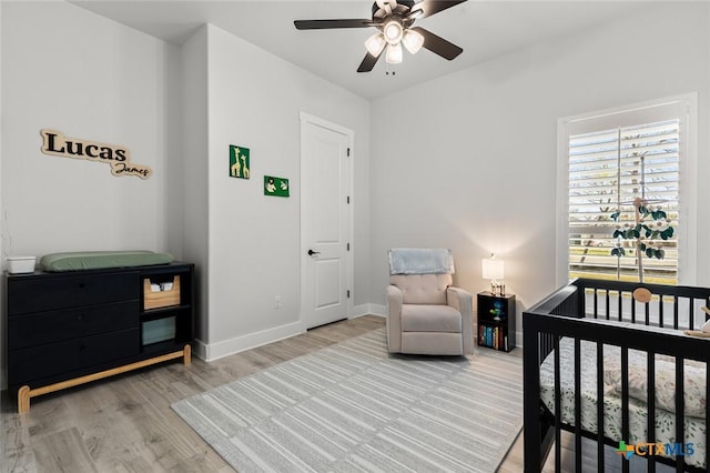 12 Lago Viento Ln, Belton, TX 76513 - bedroom with a nursery area, baseboards, a ceiling fan, and light wood finished floors