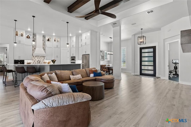 12 Lago Viento Ln, Belton, TX 76513 - living room featuring visible vents, beam ceiling, ceiling fan with notable chandelier, recessed lighting, and light wood-style flooring