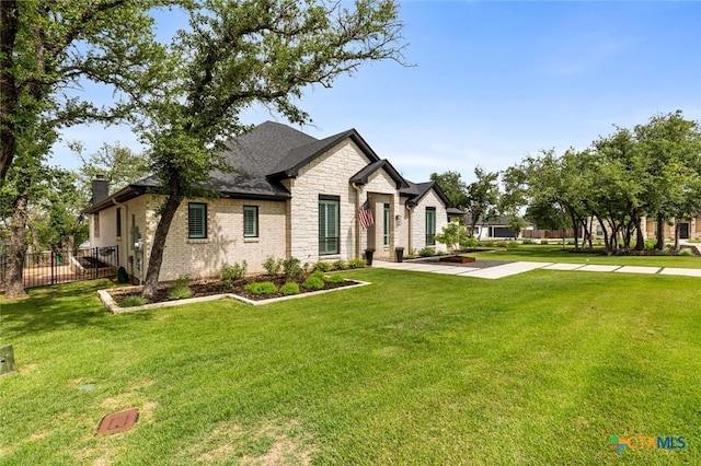 12 Lago Viento Ln, Belton, TX 76513 - french country inspired facade with fence, a chimney, stone siding, and a front lawn