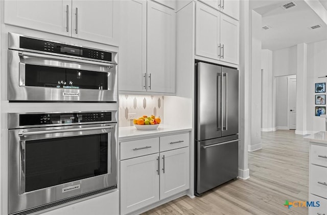 12 Lago Viento Ln, Belton, TX 76513 - kitchen featuring light countertops, appliances with stainless steel finishes, light wood-style flooring, and visible vents