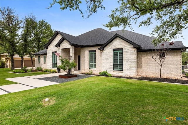 12 Lago Viento Ln, Belton, TX 76513 - view of front of house featuring roof with shingles, stone siding, brick siding, and a front yard