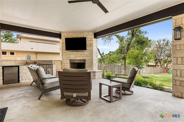 12 Lago Viento Ln, Belton, TX 76513 - view of patio / terrace featuring fence, an outdoor living space with a fireplace, exterior kitchen, area for grilling, and a ceiling fan