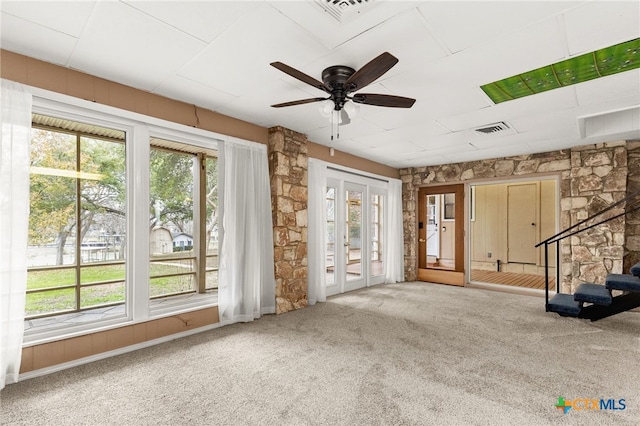 misc room featuring french doors, a healthy amount of sunlight, and carpet