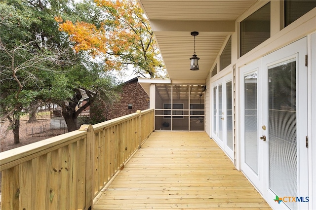 deck featuring french doors and a sunroom