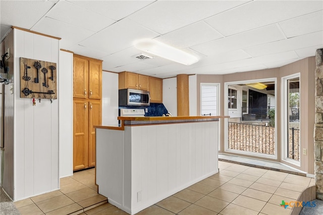 kitchen with light tile patterned flooring