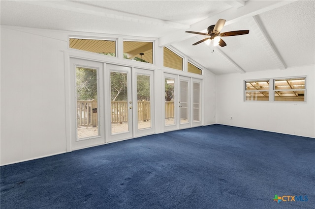 interior space with ceiling fan, lofted ceiling with beams, and a textured ceiling