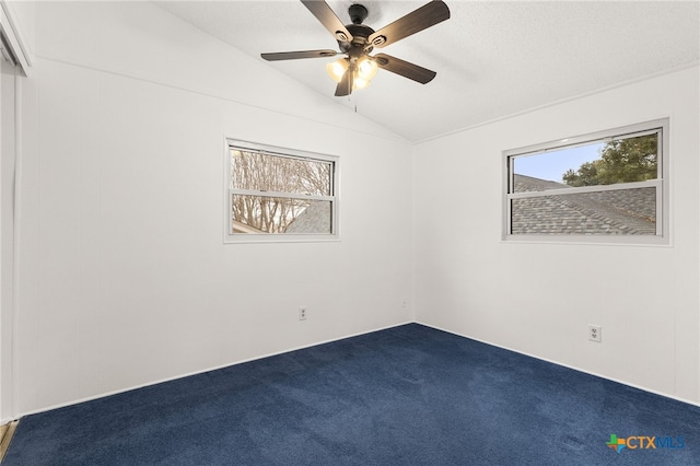 unfurnished room with ceiling fan, plenty of natural light, vaulted ceiling, and carpet