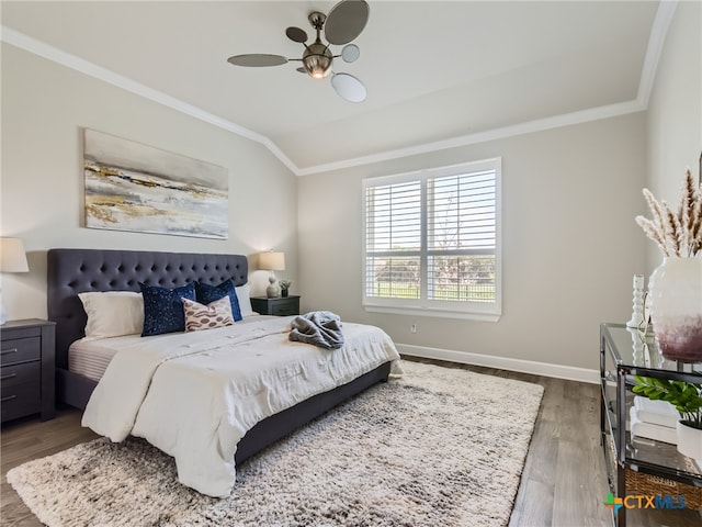 bedroom with crown molding, ceiling fan, vaulted ceiling, and hardwood / wood-style floors