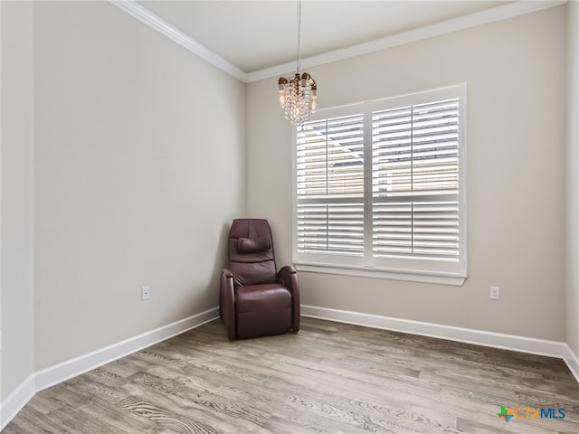 unfurnished room with ornamental molding, wood-type flooring, a wealth of natural light, and a notable chandelier