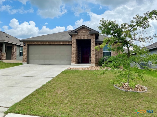 view of front of property featuring a garage and a front lawn