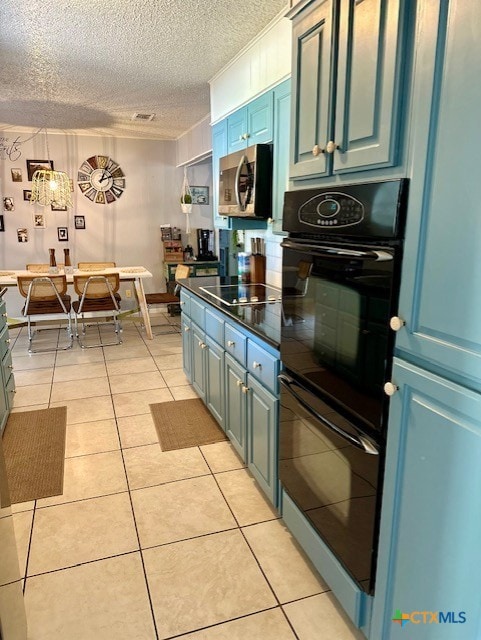 kitchen featuring blue cabinetry, black appliances, and light tile patterned floors