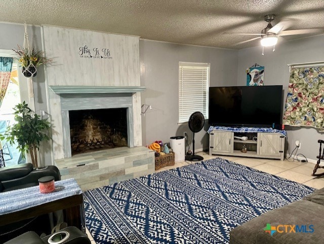 tiled living room featuring a textured ceiling and ceiling fan