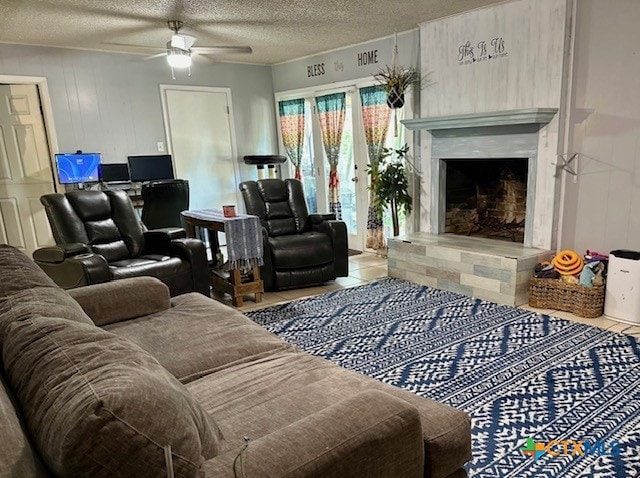 tiled living room with a textured ceiling and ceiling fan