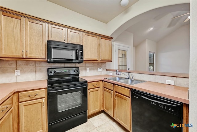 kitchen with sink, black appliances, ceiling fan, backsplash, and lofted ceiling