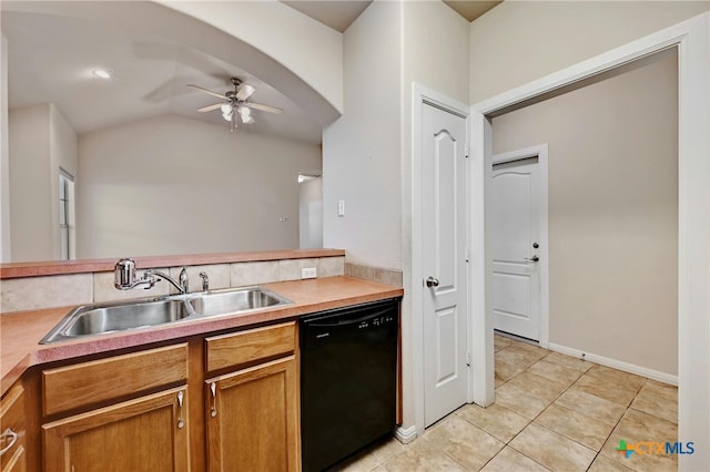 kitchen with sink, ceiling fan, light tile patterned floors, lofted ceiling, and black dishwasher