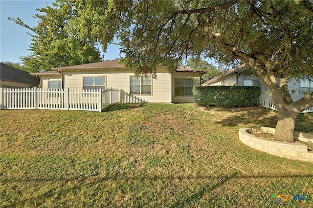 rear view of property with a yard