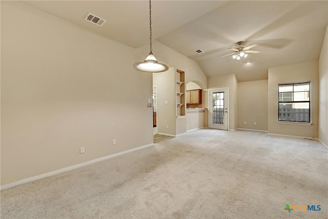 unfurnished living room featuring light carpet, ceiling fan, and vaulted ceiling