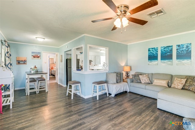 243 E Magnolia Ave, Aransas Pass, TX 78336 - living room with ceiling fan, wood finished floors, a textured ceiling, baseboards, and ornamental molding