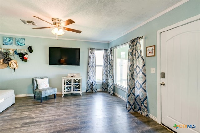 243 E Magnolia Ave, Aransas Pass, TX 78336 - sitting room featuring wood finished floors, a ceiling fan, ornamental molding, a textured ceiling, and baseboards
