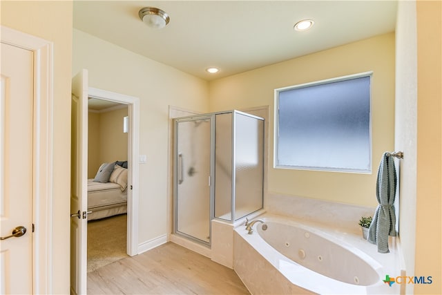 bathroom featuring hardwood / wood-style flooring and separate shower and tub