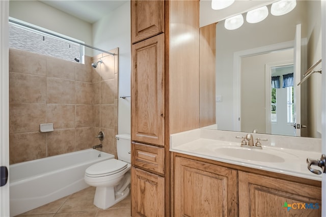 full bathroom with tile patterned flooring, tiled shower / bath, toilet, and vanity