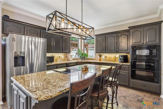 kitchen featuring light stone counters, ornamental molding, backsplash, and black appliances