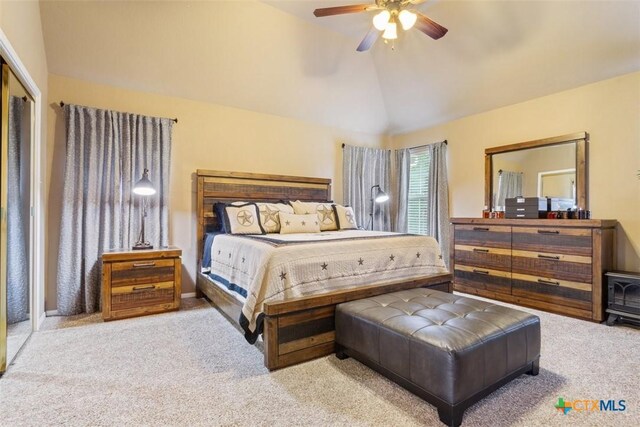 carpeted bedroom with ceiling fan and lofted ceiling