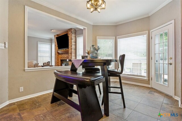 dining space with baseboards, a healthy amount of sunlight, and a fireplace
