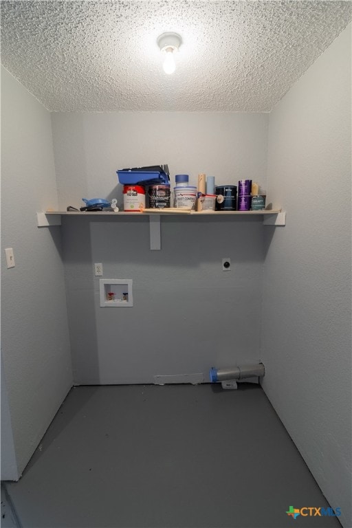 clothes washing area featuring washer hookup, a textured ceiling, and electric dryer hookup