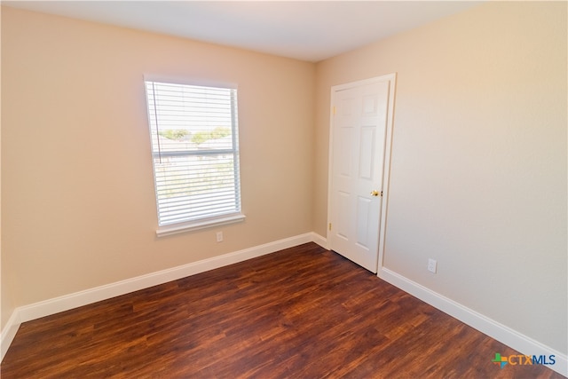 unfurnished room featuring dark hardwood / wood-style flooring