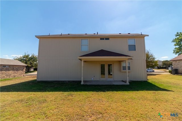 rear view of house with a yard