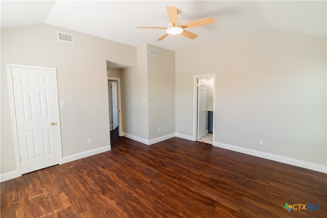 unfurnished bedroom with ensuite bath, dark hardwood / wood-style floors, ceiling fan, and vaulted ceiling