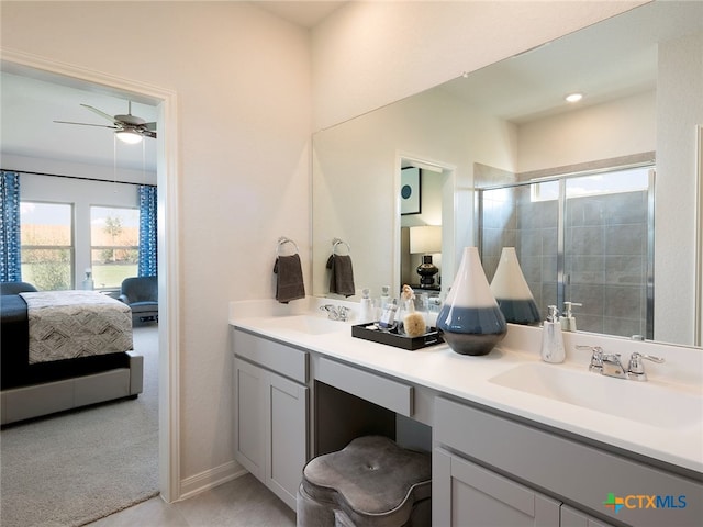 bathroom featuring ceiling fan, a shower with door, and vanity