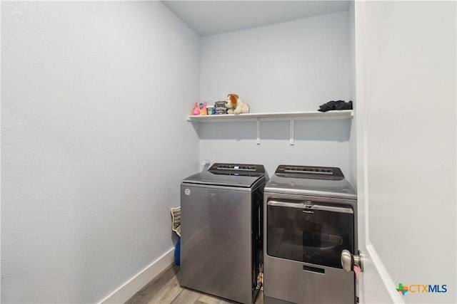 laundry area featuring light hardwood / wood-style flooring and washer and dryer