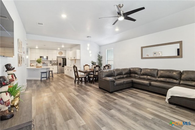 living room featuring light wood-type flooring and ceiling fan