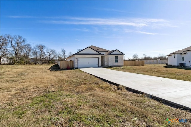 ranch-style home featuring a garage and a front yard