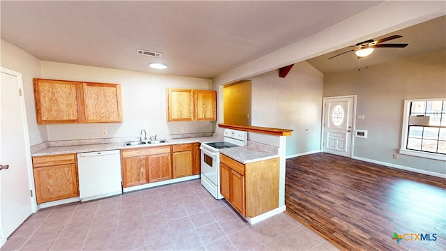 kitchen with light hardwood / wood-style floors, sink, kitchen peninsula, ceiling fan, and white appliances