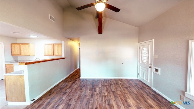 interior space with high vaulted ceiling, dark wood-type flooring, ceiling fan, and beam ceiling