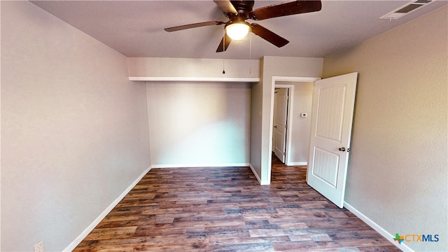 unfurnished bedroom with dark hardwood / wood-style flooring and ceiling fan