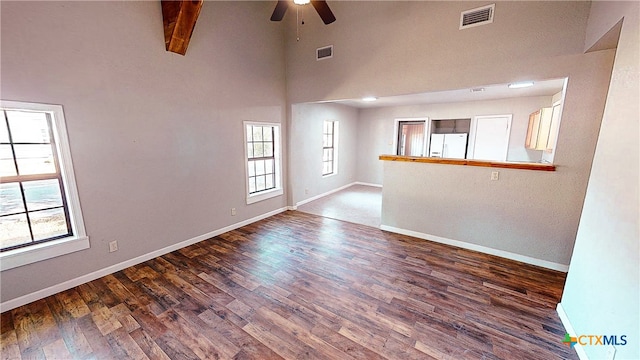 spare room with hardwood / wood-style flooring, ceiling fan, beam ceiling, and high vaulted ceiling