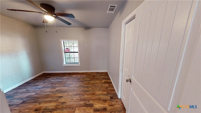 unfurnished room with dark hardwood / wood-style floors and ceiling fan