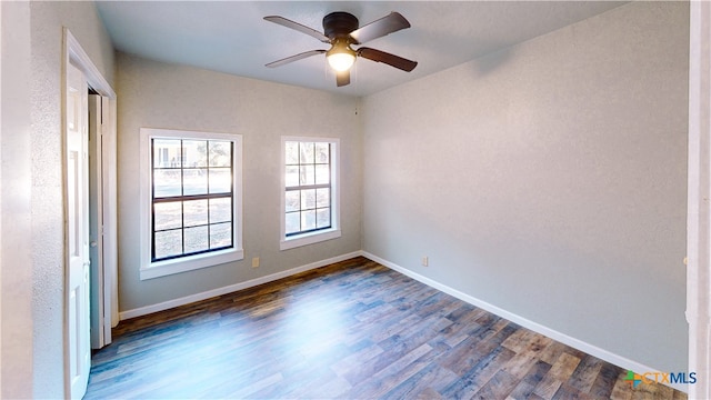 unfurnished room with dark hardwood / wood-style flooring and ceiling fan